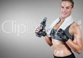 Fitness woman holding water bottle against grey background