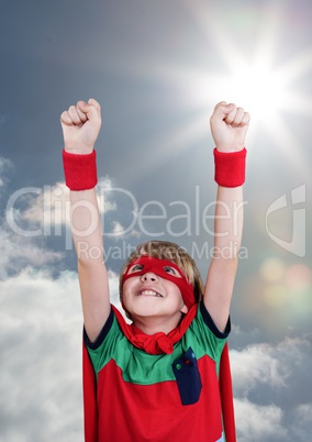 Digital composite image of smiling boy wearing superhero costume