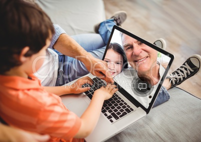 Boy having a video call with grandfather on laptop