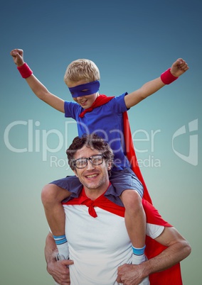 Happy father and son in red cape and mask having fun