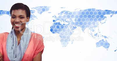 Smiling woman standing against world map with hexagonal pattern