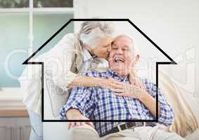 Senior woman giving kiss on senior man cheeks above outline house