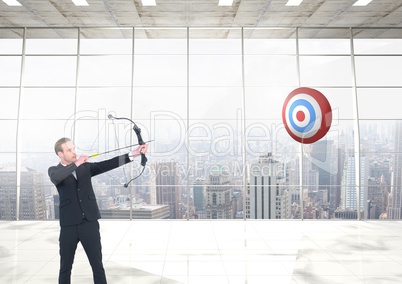 Businessman hitting with bow and arrow against cityscape background