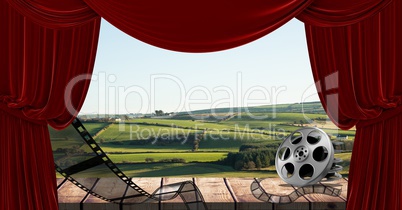 Film reel and curtain with scenic landscape in background