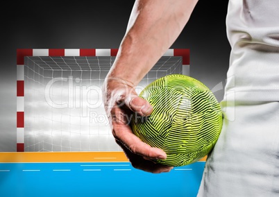 Close-up of male handball player holding ball against goal post