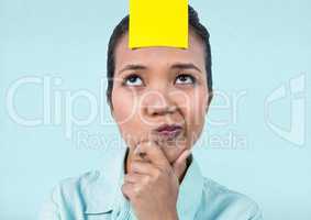 Frustrated businesswoman with sticky note stuck on her forehead