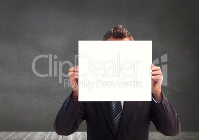 Businessman covering his face with placard