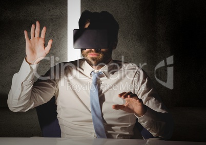 Man pretending to touch while wearing virtual reality headset