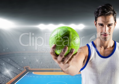 Athlete holding handball against stadium in background