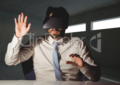 Businessman using virtual reality headset at desk