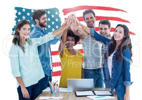 Executives doing hand stack against american flag in background at office