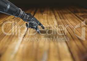 Close-up of robot hand touching wooden desk