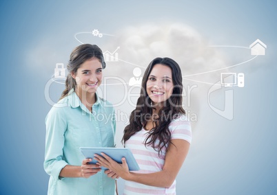 Executives holding digital tablet with networking icons and cloud in background
