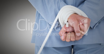 Businessman hands tied up in rope