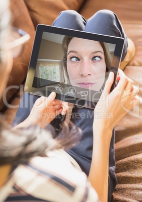 Woman having video call with friend on digital tablet