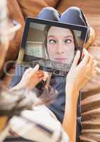 Woman having video call with friend on digital tablet