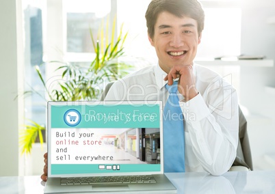 Portrait of smiling man showing online store on laptop screen