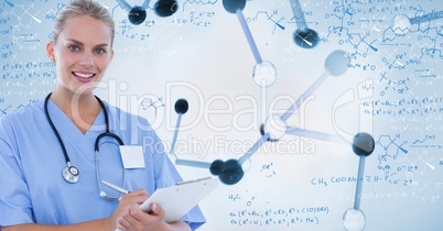 Smiling doctor writing on clipboard standing against digitally generated background