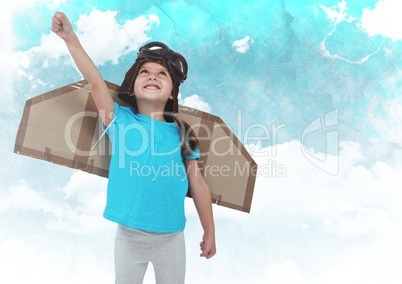 Smiling kid pretending to be a pilot against clouds