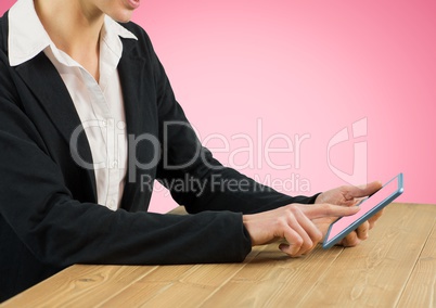 Businesswoman using digital tablet on desk