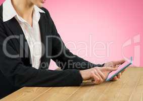 Businesswoman using digital tablet on desk