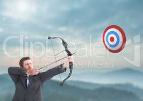 Businessman aiming at target with bow and arrow