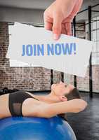 Fitness woman lying over exerciseball with hand holding text with placard