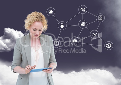 Businesswoman using digital tablet with networking icons and cloud in background