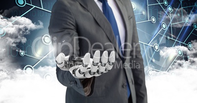 Business man with robot hand with clouds in background