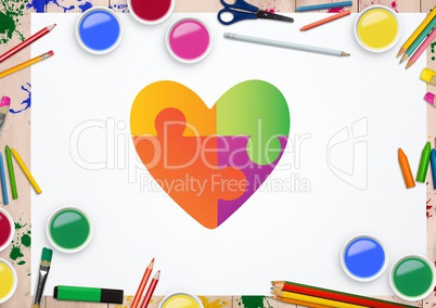 Heart shape on white card against stationary items in background