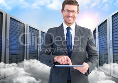 Portrait of smiling businessman using digital tablet against server and clouds background