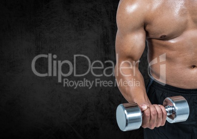 Mid section of a fit man lifting dumbbells