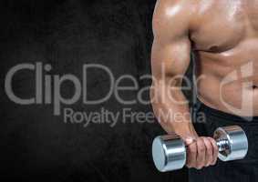 Mid section of a fit man lifting dumbbells