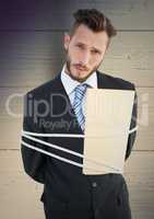 Digital composite image of a tied businessman