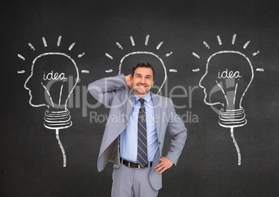Smiling businessman standing with hand on hip against innovative idea bulb