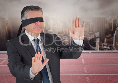 Digital composite image of blind folded businessman