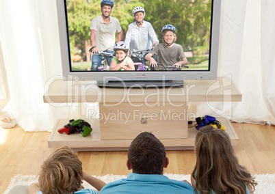 Family watching television in living room