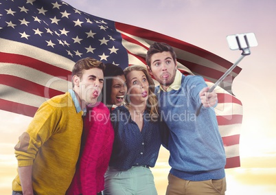 Friends taking selfie against american flag in background
