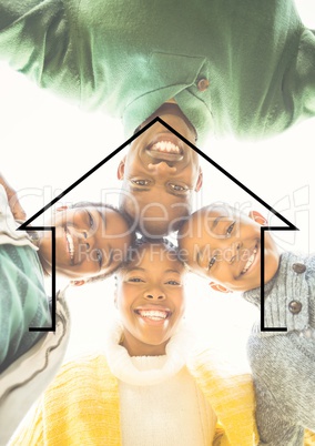 Family hugging each other against house outline in background