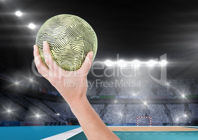 Close-up of hand holding ball and stadium in background