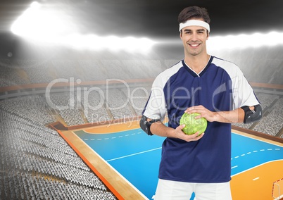Portrait of handball player holding ball in stadium