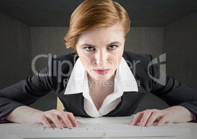 Businesswoman using keyboard on desk