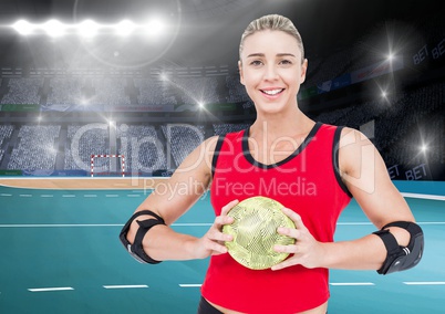 Athlete holding handball against stadium in background