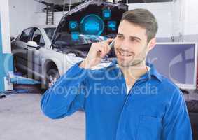 Mechanic talking on mobile phone with car mechanic interface