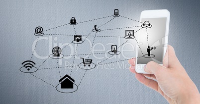 Hand holding mobile phone and networking icons on grey background