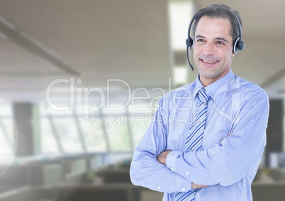 Customer service executive standing with arms crossed at office