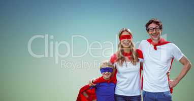 Father, mother and son in superhero costume standing against green background