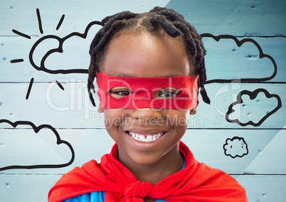 Boy in superhero costume standing against wooden plank background