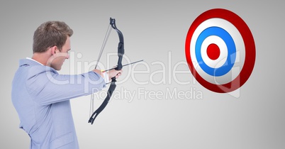 Digital composite image of businessman aiming at the target board