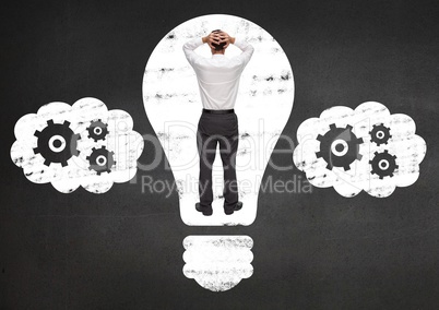 Businessman trapped in electric bulb against black background